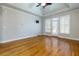 Large bedroom featuring a ceiling fan, hardwood floors, and a door to the private deck at 76 Misty View Ln, Acworth, GA 30101