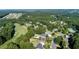 Aerial view of a golf course lined with tall trees, a pool and upscale residential neighborhood at 76 Misty View Ln, Acworth, GA 30101