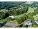 Aerial view of a golf course with sand traps surrounded by tall trees and upscale residential homes at 76 Misty View Ln, Acworth, GA 30101