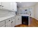 Eat-in kitchen featuring a breakfast bar, stainless steel dishwasher, white cabinets, and marble countertops at 76 Misty View Ln, Acworth, GA 30101