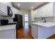 Contemporary kitchen with white cabinets, modern appliances, and marble countertops at 76 Misty View Ln, Acworth, GA 30101