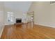 Spacious living room boasts hardwood flooring, a fireplace, and abundant natural light from large windows at 76 Misty View Ln, Acworth, GA 30101