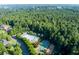 Aerial view of community pool, splash pad and basketball court surrounded by green spaces and homes at 76 Misty View Ln, Acworth, GA 30101