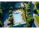 Aerial view of community swimming pool, splash pad, basketball court, seating and landscaped lawn at 76 Misty View Ln, Acworth, GA 30101