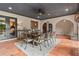 Charming outdoor dining area featuring terracotta tile, beamed ceiling, and stylish furniture at 130 Woodlawn Ne Dr, Marietta, GA 30067