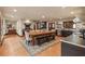 Open dining area with a rustic wood table, chairs and decorative rug adjacent to an adobe fireplace at 130 Woodlawn Ne Dr, Marietta, GA 30067