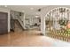 Staircase and foyer featuring decorative tile, wrought iron, and view to living room at 130 Woodlawn Ne Dr, Marietta, GA 30067
