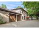 Exterior of home with garage, paved driveway, and an outdoor seating area at 130 Woodlawn Ne Dr, Marietta, GA 30067