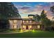 Beautiful stucco home with red tile roof, manicured lawn, mature trees, and walkway leading to the front door at 130 Woodlawn Ne Dr, Marietta, GA 30067