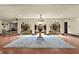 Grand foyer with arched openings, wrought iron details, a large area rug, and views to a fireplace in the distance at 130 Woodlawn Ne Dr, Marietta, GA 30067