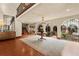 Elegant foyer with iron railing, arched doorways, tile flooring and a view of the courtyard and staircase at 130 Woodlawn Ne Dr, Marietta, GA 30067