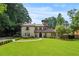 Elegant front exterior with a well-maintained lawn and manicured landscaping at 130 Woodlawn Ne Dr, Marietta, GA 30067