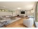Bright and airy living room with hardwood floors, neutral furniture, and large arched windows at 130 Woodlawn Ne Dr, Marietta, GA 30067
