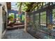 Enclosed patio with stone flooring, lush greenery, and metal lattice divider at 130 Woodlawn Ne Dr, Marietta, GA 30067