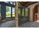 Charming sunroom patio with gravel floor, metal lattice divider, and access to the outdoors at 130 Woodlawn Ne Dr, Marietta, GA 30067