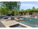 Sparkling pool and spa area with patio furniture, lush greenery, and outdoor living space at 130 Woodlawn Ne Dr, Marietta, GA 30067