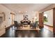 Sitting room with fireplace, patterned chairs, dark floors and doors to a courtyard at 130 Woodlawn Ne Dr, Marietta, GA 30067