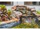 Close-up shot of an outdoor water feature with rocks, plants, and flowing water at 130 Woodlawn Ne Dr, Marietta, GA 30067