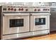 Close up of a stainless steel Wolf double oven with red knobs and professional design at 130 Woodlawn Ne Dr, Marietta, GA 30067