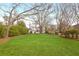 Lush backyard with a large lawn, mature trees, and a view of the house and garage at 205 Mead Rd, Decatur, GA 30030
