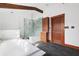 Bathroom featuring a soaking tub, glass shower, wood cabinets, and a patterned shower wall at 205 Mead Rd, Decatur, GA 30030