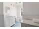 Bathroom featuring blue tile flooring, beadboard paneling, and classic white vanity at 205 Mead Rd, Decatur, GA 30030