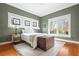 Bedroom with stained glass windows, hardwood floors, and stylish furnishings at 205 Mead Rd, Decatur, GA 30030