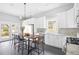 Bright kitchen featuring white cabinetry, stainless steel appliances, and a large island with barstool seating at 205 Mead Rd, Decatur, GA 30030
