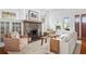 Cozy living room features a stone fireplace, hardwood floors, and abundant natural light at 205 Mead Rd, Decatur, GA 30030