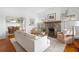 Elegant living room with a stone fireplace, hardwood floors, and seamless flow to the dining area at 205 Mead Rd, Decatur, GA 30030