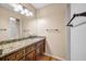 Bathroom featuring granite counters, wood floors, and framed mirror at 3736 Bloxham Ct, Atlanta, GA 30341