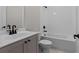 Stylish bathroom with gray cabinets, modern fixtures, and a bathtub with white subway tile surround at 4770 Briscoe Dr, Cumming, GA 30028