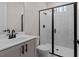 Modern bathroom with a glass-enclosed shower, sleek fixtures and gray vanity at 4770 Briscoe Dr, Cumming, GA 30028