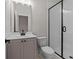 Modern bathroom featuring a sleek vanity with black hardware and a glass-enclosed shower at 4770 Briscoe Dr, Cumming, GA 30028
