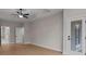 Spacious bedroom featuring wood flooring, a ceiling fan, and patio doors with abundant natural light at 4770 Briscoe Dr, Cumming, GA 30028