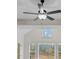Modern ceiling fan with a light fixture, and a window with a view of the outdoors at 4770 Briscoe Dr, Cumming, GA 30028