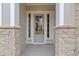 Close up view of the home's glass front door with stone pillars and sidelights at 4770 Briscoe Dr, Cumming, GA 30028