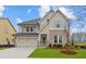 Charming two-story home with stone accents, a two-car garage, and a well-manicured lawn at 4770 Briscoe Dr, Cumming, GA 30028