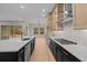 Open kitchen with stainless steel appliances, an island with counter seating and a seamless flow to the outdoor patio at 4770 Briscoe Dr, Cumming, GA 30028