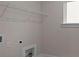 Functional laundry room with a wire rack, washer hookups, and a window for ventilation at 4770 Briscoe Dr, Cumming, GA 30028