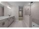 Large bathroom featuring double sinks, gray cabinets, modern hardware, and a glass shower at 4770 Briscoe Dr, Cumming, GA 30028