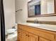 Stylish bathroom vanity featuring granite countertop, mirror and tile floors at 798 Mann Rd, Villa Rica, GA 30180