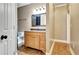 Neutral bathroom with a stylish vanity, mirror and tile floors at 798 Mann Rd, Villa Rica, GA 30180