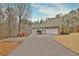 Side view of the home featuring an attached two-car garage and long driveway at 798 Mann Rd, Villa Rica, GA 30180