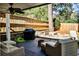 Cozy back porch with outdoor seating, grill, and a fire pit with a retaining wall at 807 Longwood Dr, Atlanta, GA 30305