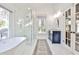 Elegant bathroom showcases modern soaking tub, sleek glass shower, and double door access at 807 Longwood Dr, Atlanta, GA 30305