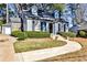 Charming blue two-story home with manicured front yard and inviting walkway at 807 Longwood Dr, Atlanta, GA 30305