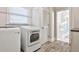 This laundry room has a modern washer/dryer, storage and leads to a bathroom at 807 Longwood Dr, Atlanta, GA 30305