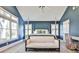 Main bedroom with sitting area, designer chair, and ample natural light from multiple windows at 807 Longwood Dr, Atlanta, GA 30305