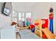 Colorful playroom features large windows, a TV, and plenty of space for toys and activities at 807 Longwood Dr, Atlanta, GA 30305